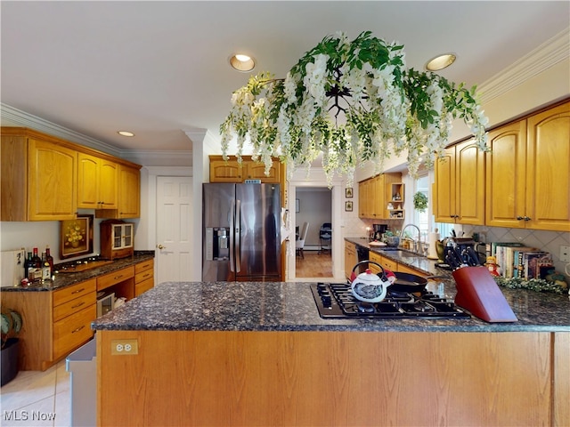 kitchen with stainless steel fridge, crown molding, a peninsula, black gas stovetop, and a sink