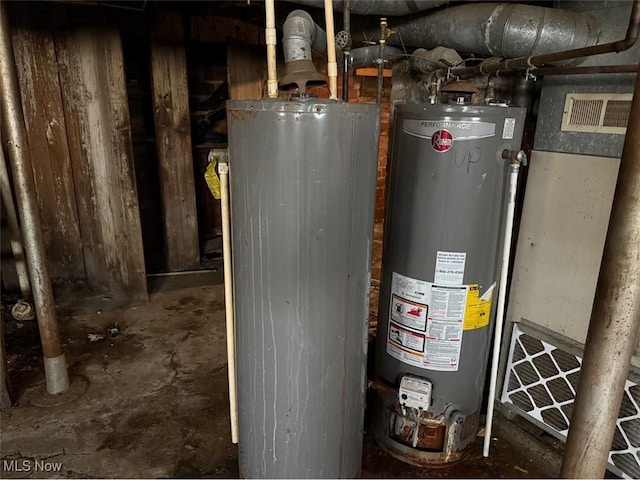 utility room featuring water heater and visible vents