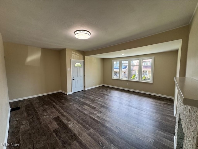 interior space featuring dark wood finished floors and baseboards