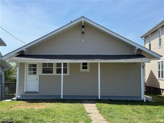 back of property with a lawn