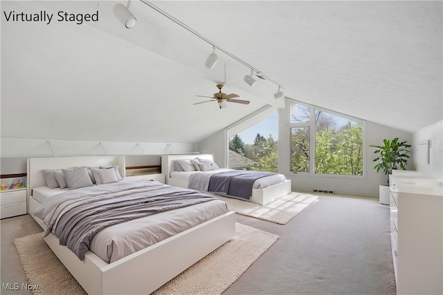 bedroom featuring visible vents, ceiling fan, light colored carpet, and vaulted ceiling