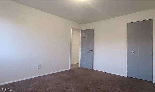 unfurnished bedroom with carpet and baseboards