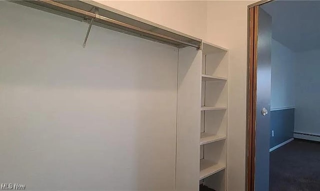 spacious closet with a baseboard radiator