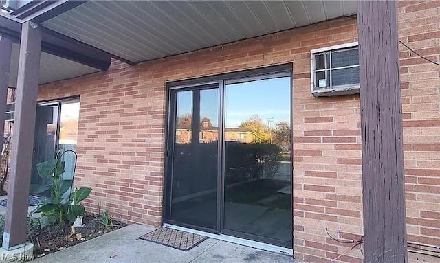 entrance to property featuring brick siding