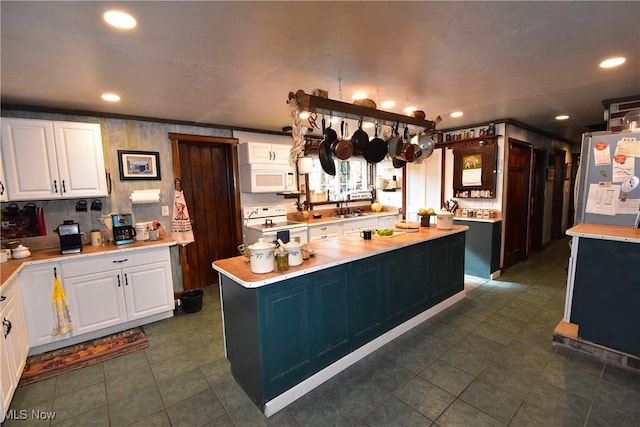 kitchen with light countertops, a sink, white cabinetry, and white appliances
