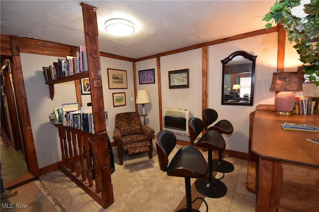 sitting room featuring heating unit and baseboards