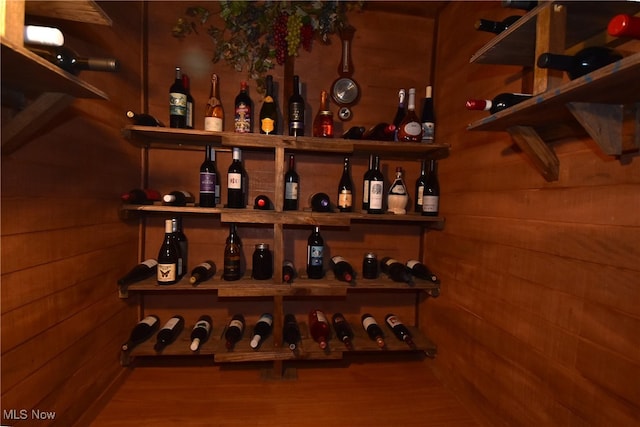 wine room with wooden walls and a dry bar