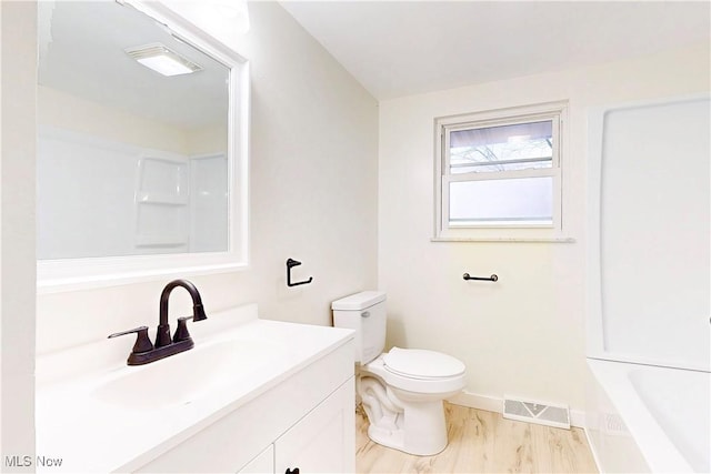 full bathroom with visible vents, baseboards, walk in shower, toilet, and vanity