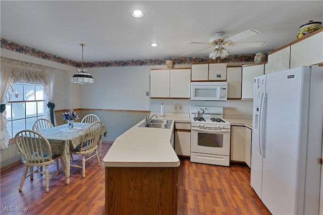 810 Southwestern Run Unit 19, Poland, OH 44514 - kitchen featuring white cabinets, a sink, white appliances, a ceiling fan, and a peninsula