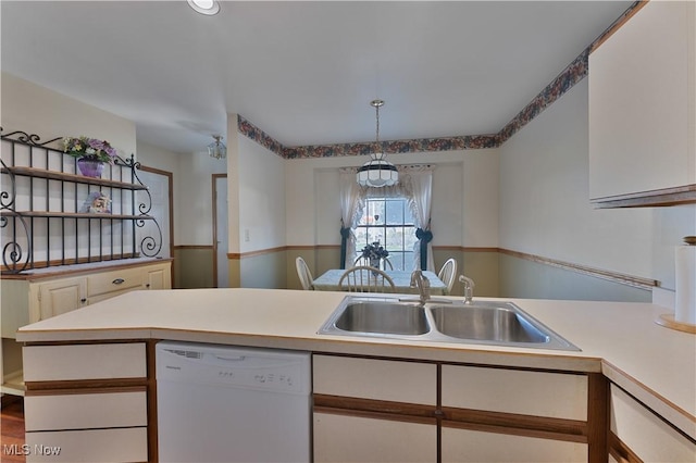 810 Southwestern Run Unit 19, Poland, OH 44514 - kitchen featuring white cabinetry, a sink, light countertops, white dishwasher, and hanging light fixtures