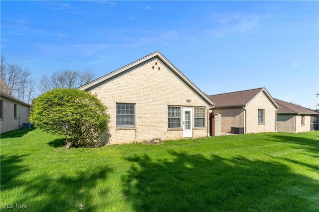810 Southwestern Run Unit 19, Poland, OH 44514 - rear view of property featuring brick siding, central air condition unit, and a lawn