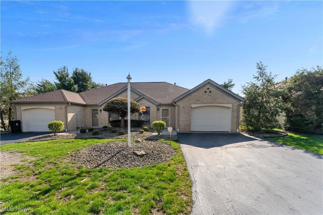 810 Southwestern Run Unit 19, Poland, OH 44514 - single story home featuring a front lawn, an attached garage, aphalt driveway, and brick siding