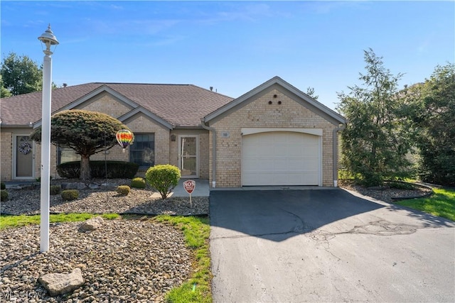 810 Southwestern Run Unit 19, Poland, OH 44514 - single story home with driveway, a shingled roof, an attached garage, and brick siding