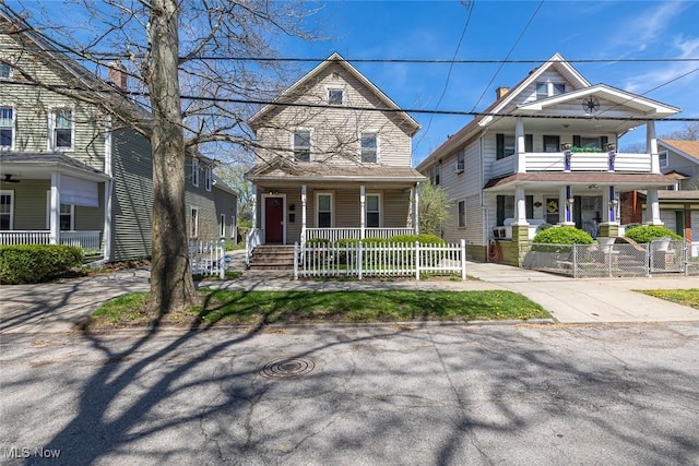 view of front of property with covered porch and a fenced front yard