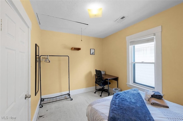 office space featuring baseboards, visible vents, attic access, and carpet