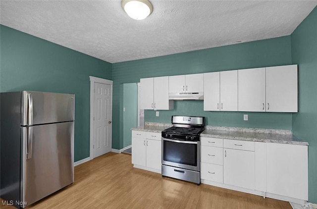 kitchen with white cabinetry, appliances with stainless steel finishes, under cabinet range hood, and light wood-style floors