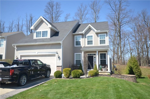 traditional-style home with driveway, a front yard, and a garage