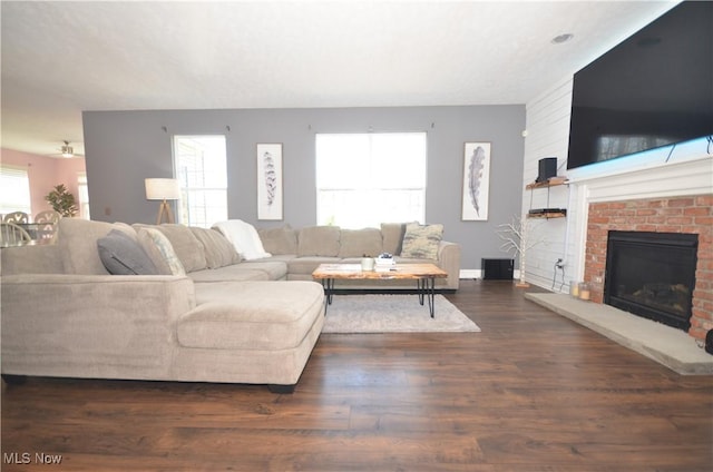 living room with wood finished floors and a fireplace