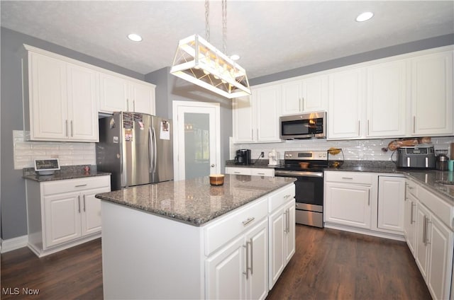 kitchen featuring white cabinets, backsplash, and appliances with stainless steel finishes