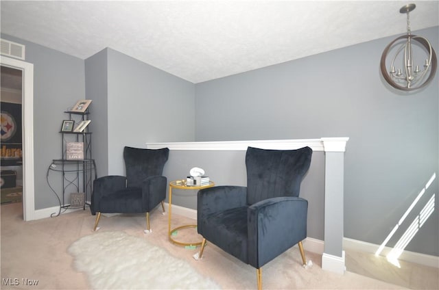 sitting room featuring baseboards, visible vents, a notable chandelier, and carpet