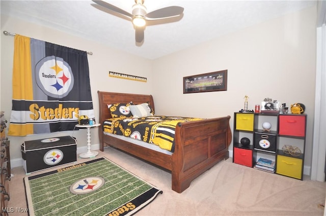 carpeted bedroom with a ceiling fan and baseboards