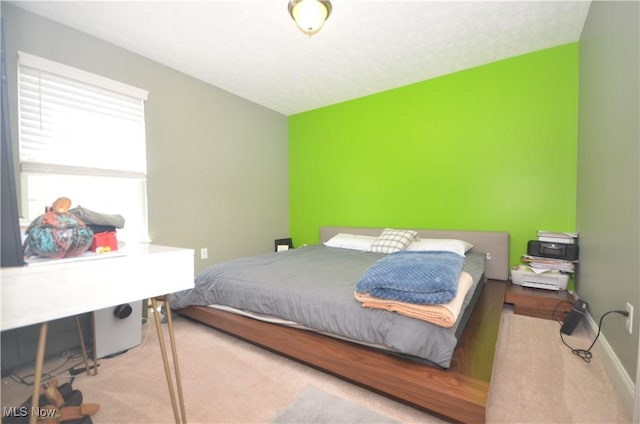 carpeted bedroom featuring baseboards