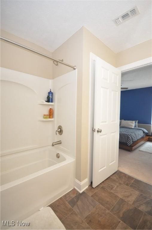 ensuite bathroom with shower / bathing tub combination, visible vents, ensuite bathroom, and baseboards
