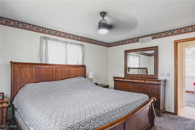 bedroom featuring visible vents, dark carpet, ceiling fan, and baseboards