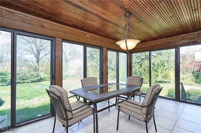 sunroom featuring outdoor dining area