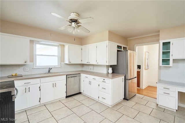 kitchen featuring a sink, light tile patterned flooring, ceiling fan, white cabinets, and appliances with stainless steel finishes