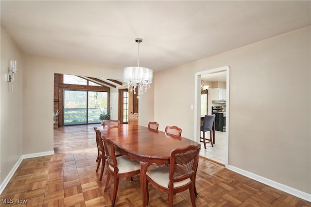dining area with an inviting chandelier and baseboards