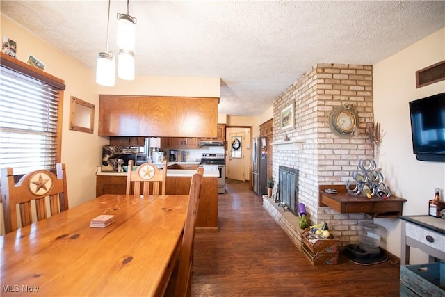 dining space with a fireplace, a textured ceiling, and dark wood-type flooring