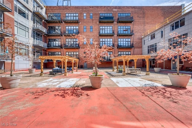 view of property's community featuring a pergola and a patio area