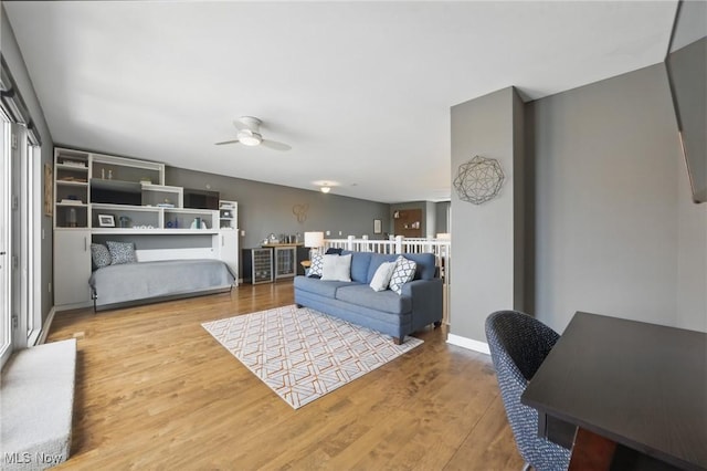living room featuring wood finished floors and a ceiling fan