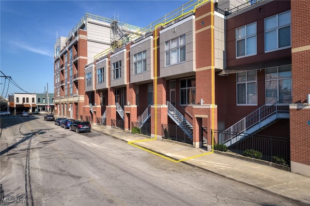 1951 W 26th St Unit Th5, Cleveland, OH 44113 - view of building exterior with uncovered parking and stairs