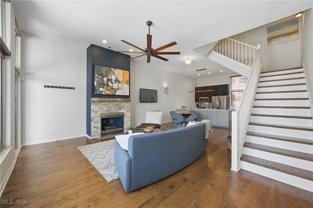 1951 W 26th St Unit Th5, Cleveland, OH 44113 - living room with a ceiling fan, a stone fireplace, stairway, recessed lighting, and dark wood-style flooring