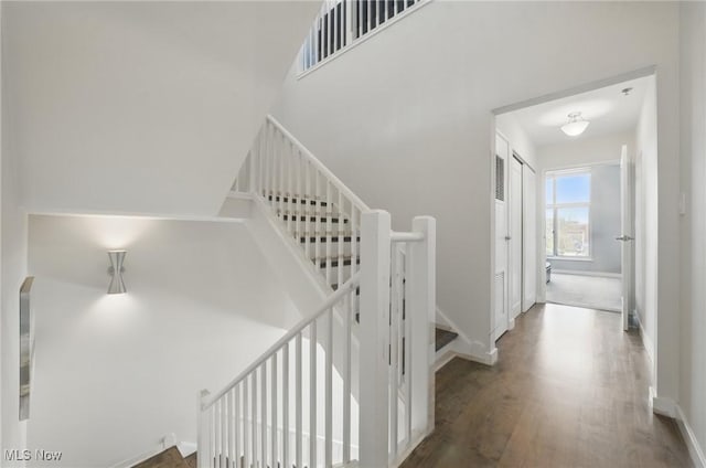 stairway featuring wood finished floors and baseboards