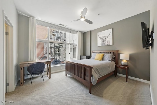 carpeted bedroom with visible vents, ceiling fan, and baseboards