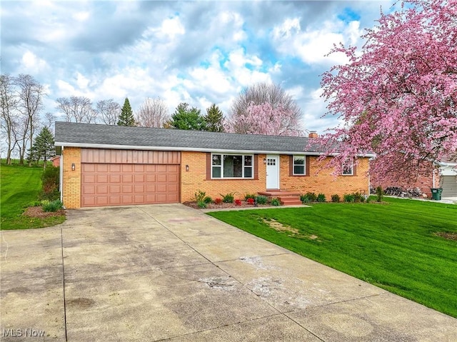 ranch-style home featuring a front lawn, driveway, an attached garage, and brick siding
