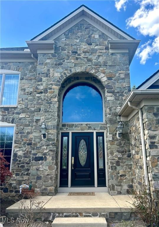 entrance to property with stone siding