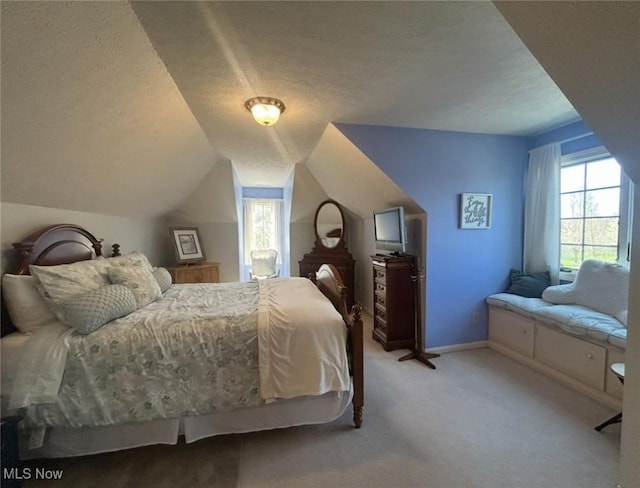 bedroom with a textured ceiling, baseboards, vaulted ceiling, and light carpet