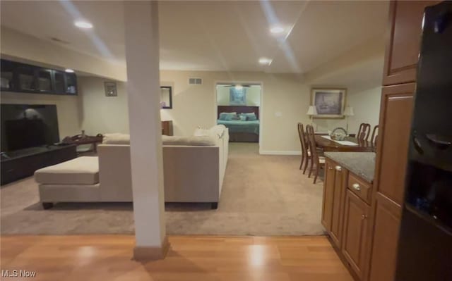 living room with recessed lighting, light colored carpet, baseboards, visible vents, and lofted ceiling