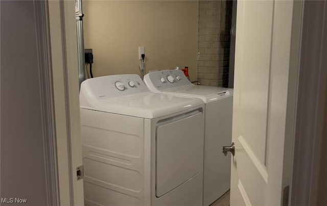 clothes washing area featuring laundry area and washing machine and dryer