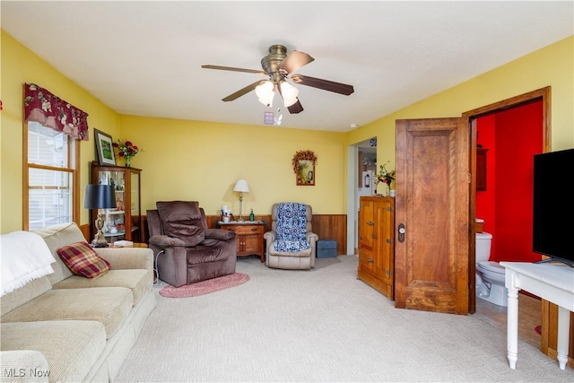 carpeted living area featuring ceiling fan
