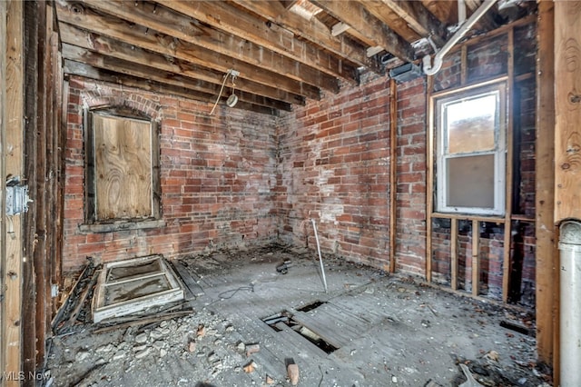misc room with brick wall