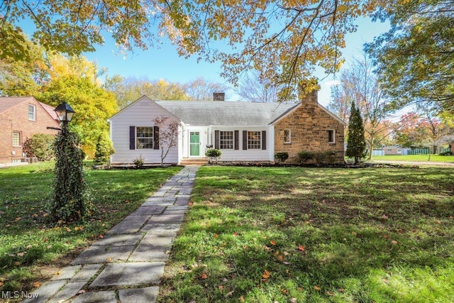 view of front of property featuring a front lawn and a chimney