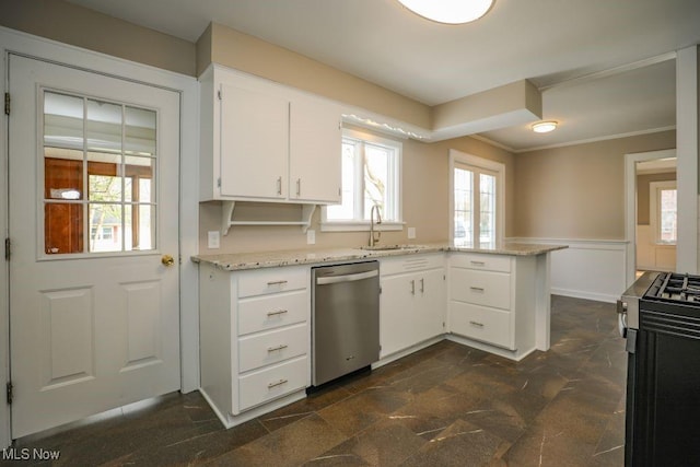 kitchen featuring a sink, a wainscoted wall, a peninsula, dishwasher, and gas range