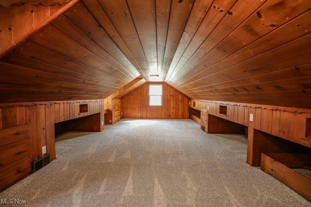 additional living space with wood walls, wooden ceiling, vaulted ceiling, and carpet