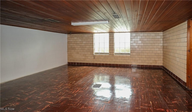 bonus room featuring visible vents, concrete block wall, and wooden ceiling