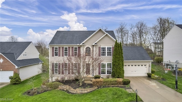 view of front of home featuring driveway, a front lawn, and a garage